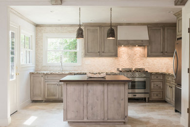 Inspiration for a mid-sized transitional l-shaped eat-in kitchen in Houston with an undermount sink, beaded inset cabinets, distressed cabinets, granite benchtops, beige splashback, stone tile splashback, stainless steel appliances, travertine floors and with island.