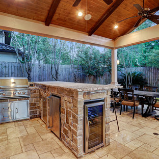 Small mediterranean backyard patio in Houston with an outdoor kitchen, tile and a roof extension.
