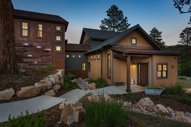 Mountain style concrete floor and gray floor entryway photo in Denver with brown walls and a dark wood front door