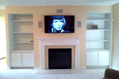 This is an example of a classic living room in Other with a wall mounted tv.