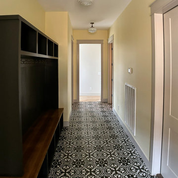 Stylish Entryway Mudroom with Bold Patterned Tile and Custom Storage