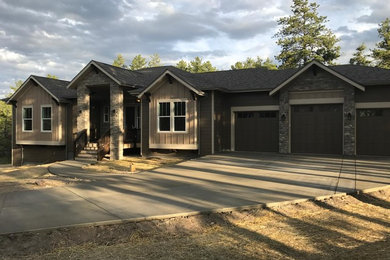 This is an example of a mid-sized country one-storey brown house exterior in Denver with wood siding, a hip roof and a shingle roof.