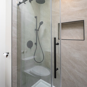 Frameless Glass Shower with Matte Black Fixtures – Modern Bathroom Renovation Co