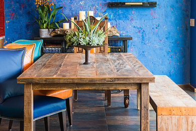Example of an eclectic dining room design in Los Angeles with no fireplace and blue walls