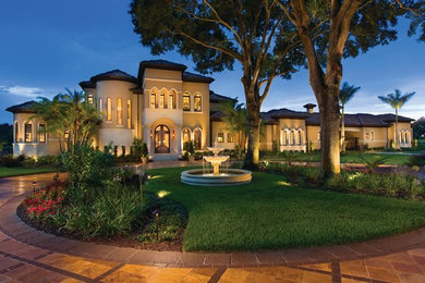 Inspiration for a large mediterranean front yard driveway in Tampa with a garden path and concrete pavers.