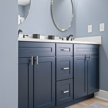 Warm and Cohesive Multi-Bathroom Design In Nokesville