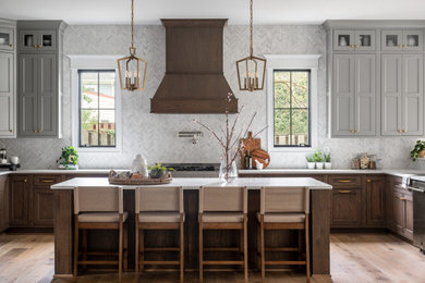 Example of a large transitional u-shaped eat-in kitchen design in DC Metro with recessed-panel cabinets, gray cabinets, quartz countertops, an island and white countertops