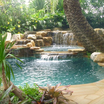 pool waterfall and  tropical gardens