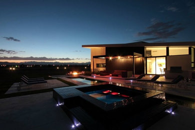 Inspiration for a mid-sized modern backyard concrete and rectangular lap hot tub remodel in Denver