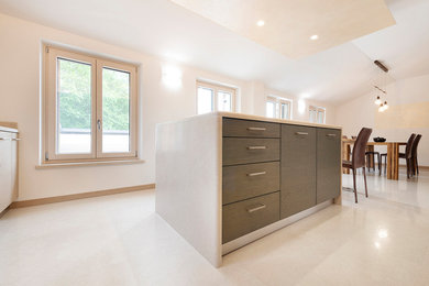 This is an example of a contemporary kitchen in Other with limestone benchtops, limestone floors, with island and beige benchtop.