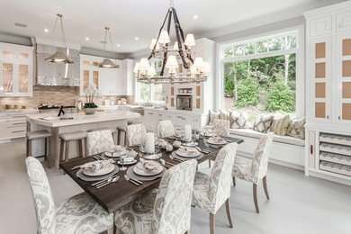 Inspiration for a large coastal u-shaped light wood floor eat-in kitchen remodel in Other with a farmhouse sink, white cabinets, beige backsplash, stainless steel appliances and an island