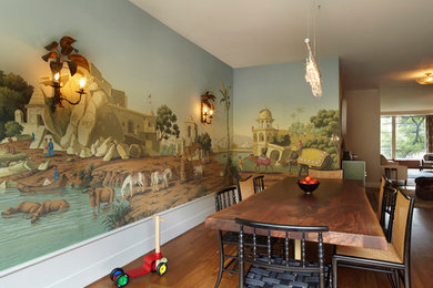 Inspiration for a mid-sized modern medium tone wood floor and brown floor kitchen/dining room combo remodel in New York with multicolored walls and no fireplace