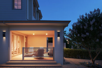 This is an example of a large country wood railing back porch design in San Francisco with a roof extension.