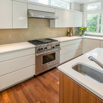 High gloss painted cabinets with integrated handles in a contemporary kitchen