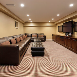 Photo of a large classic enclosed home cinema in Detroit with beige walls, carpet, a wall mounted tv and multi-coloured floors.