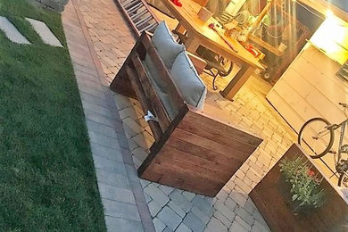 This is an example of a mid-sized traditional backyard patio in Chicago with brick pavers.