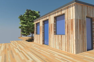 Design ideas for a small rural bungalow detached house in Sussex with wood cladding, a half-hip roof and a green roof.