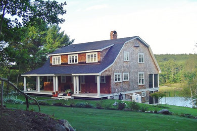 Example of a large arts and crafts red two-story wood house exterior design in Portland Maine with a gambrel roof and a shingle roof