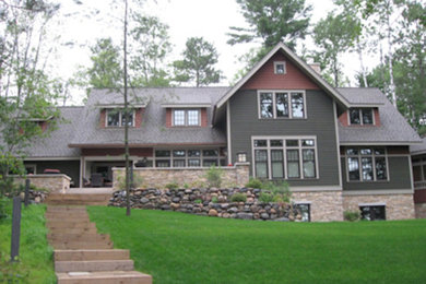 Large transitional gray two-story concrete fiberboard exterior home photo in Other