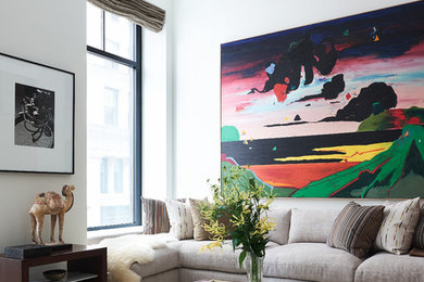 Trendy carpeted and beige floor living room photo in New York with white walls