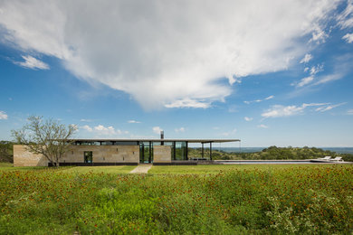 Inspiration for a modern one-story stone exterior home remodel in Austin