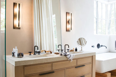 Small transitional medium tone wood floor freestanding bathtub photo in Cleveland with light wood cabinets, yellow walls and beige countertops