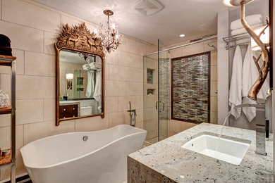 Example of a mid-sized transitional master beige tile freestanding bathtub design in Denver with flat-panel cabinets, dark wood cabinets, a one-piece toilet and an undermount sink
