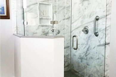 Example of a transitional gray tile porcelain tile and gray floor corner shower design in Austin with gray walls and a hinged shower door