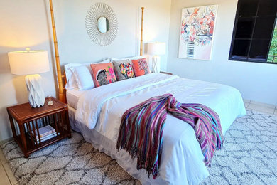 Large eclectic master ceramic tile and beige floor bedroom photo in Other with white walls