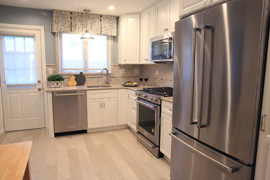 Kitchen - small traditional l-shaped gray floor kitchen idea in Philadelphia with an undermount sink, recessed-panel cabinets, white cabinets, quartz countertops, beige backsplash, porcelain backsplash, stainless steel appliances and no island