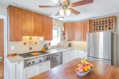Example of a small trendy l-shaped kitchen design in Philadelphia with shaker cabinets, granite countertops and an island