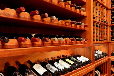 Example of a large classic terra-cotta tile wine cellar design in Dallas