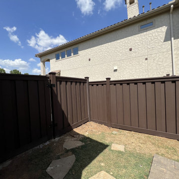 Dark Brown Composite Trex Fence and Black Iron Fence