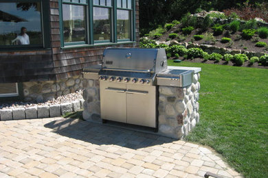 Patio - mid-sized traditional backyard brick patio idea in Providence with a fire pit and no cover