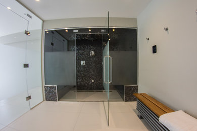 This is an example of a medium sized modern shower room bathroom in Surrey with a walk-in shower, multi-coloured walls, porcelain flooring, white floors and a hinged door.