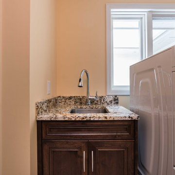 Transitional Style Laundry/Mudroom With Medium Stained Maple Cabinets