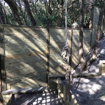 Lattice gate set in a aluminum frame alongside a lateral fence offset with 4by6s