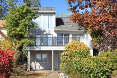 Inspiration for a mid-sized coastal gray two-story vinyl gable roof remodel in Other