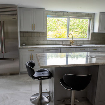 Transitional Kitchen Done in a 2 Tone Color With Integrated Dining Table