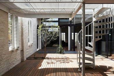 This is an example of a small industrial deck in Melbourne with metal railing.