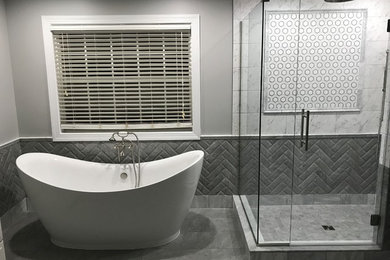 Large transitional master gray tile, white tile and subway tile porcelain tile and gray floor bathroom photo in Other with gray walls and a hinged shower door
