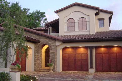 Design ideas for a mid-sized mediterranean two-storey stucco beige exterior in Orlando with a hip roof.