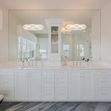 Expansive Vanity and Mirrored Wall Elevate Bright Coastal Bath