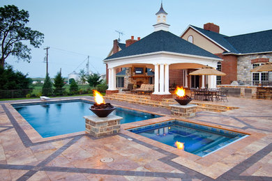 Inspiration for a large contemporary backyard rectangular lap pool in Other with natural stone pavers and a hot tub.