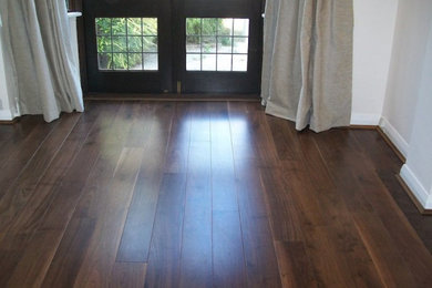 Photo of a traditional living room in Surrey with dark hardwood flooring.