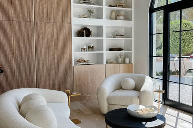 Medium sized modern study in Phoenix with light hardwood flooring and beige floors.