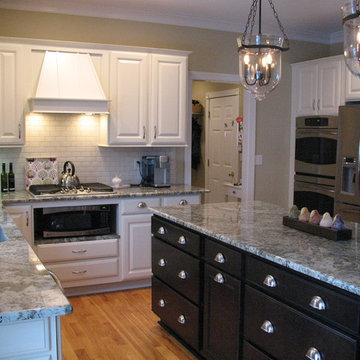 Medium color wood to off white with white subway tile and granite counter tops