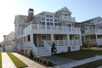Example of a beach style beige concrete fiberboard exterior home design in Philadelphia