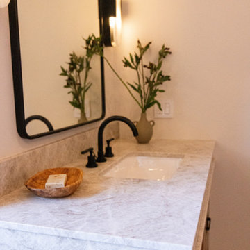Stone counter with black widespread faucet