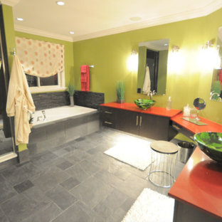 Bathroom - large master slate floor and gray floor bathroom idea in New York with flat-panel cabinets, brown cabinets, green walls, a vessel sink, solid surface countertops and red countertops